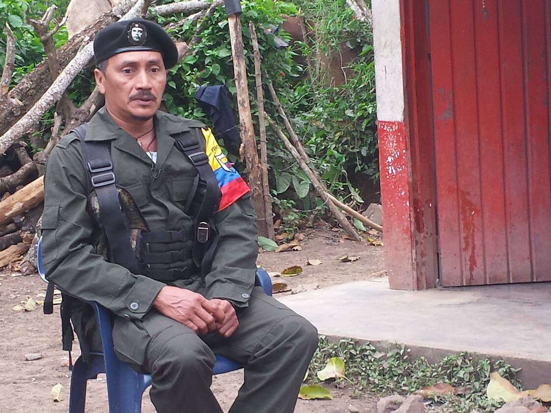 Member of the Farc sitting on a chair.