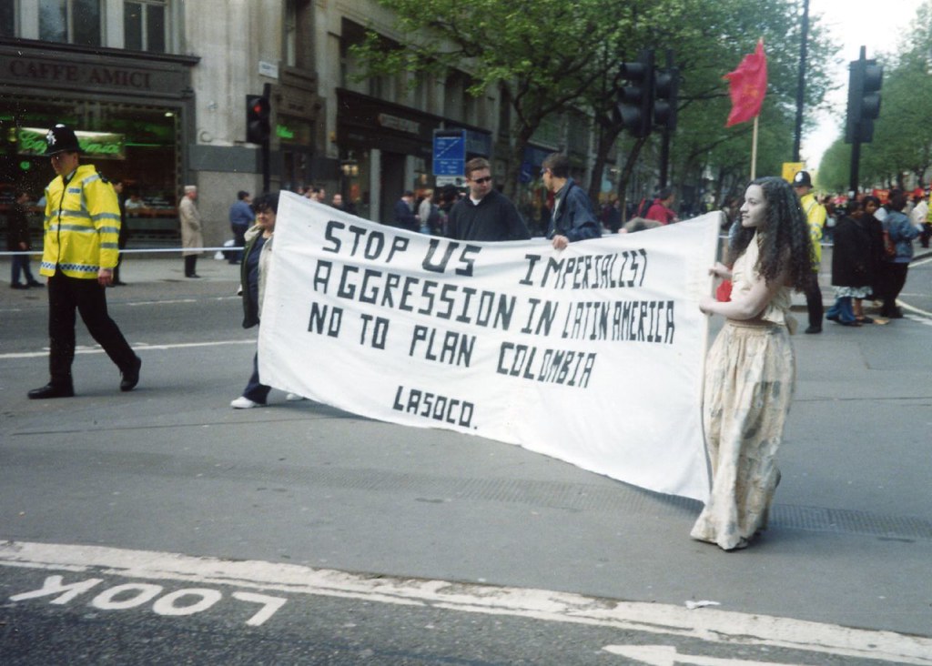 People holding a banner saying "Stop US Imperialist agression in Latin America; no to plan colombia; lasoco."