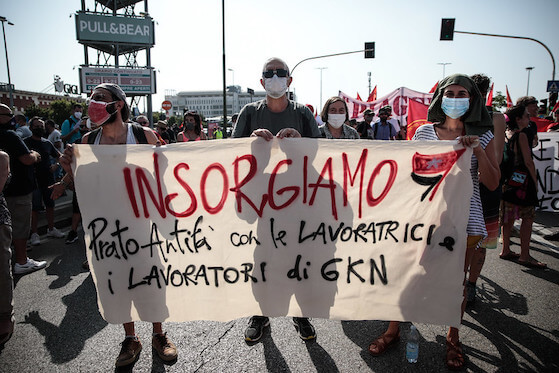Workers hold a banner that reads: "insorgiamo, prato Antifa con le lavoratrici i lavoratori de GKN